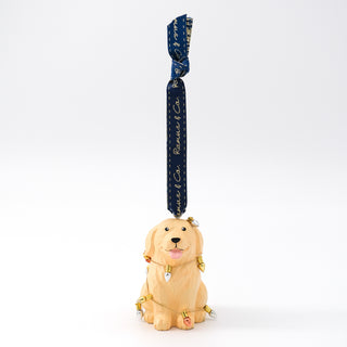 Hanging carved golden retriever ornament with blue ribbon loop