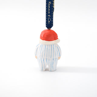 Carved Santa ornament back view with red hat and blue striped outfit; hanging blue ribbon.