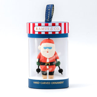 Hand-carved ski Santa ornament inside clear gift tube with RAMUS & CO label